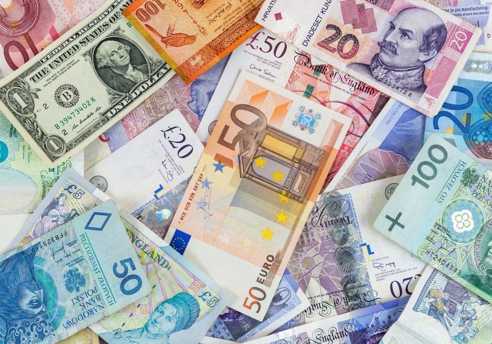 Different currencies banknotes background